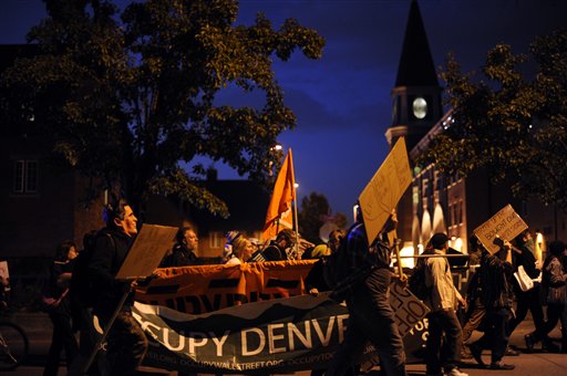Occupy Denver protesters rally against the presidential debate around the University of Denver campus on Wednesday. About 150 protesters shouted slogans denouncing a two-party system and the war in Afghanistan and demanding affordable health care.