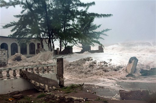 Waves, brought by Hurricane Sandy, crash on a house in the Caribbean Terrace neighborhood in eastern Kingston, Jamaica, Wednesday, Oct. 24, 2012. Hurricane Sandy pounded Jamaica with heavy rain as it headed for landfall near the country's most populous city on a track that would carry it across the Caribbean island to Cuba, and a possible threat to Florida. (AP Photo/Collin Reid)