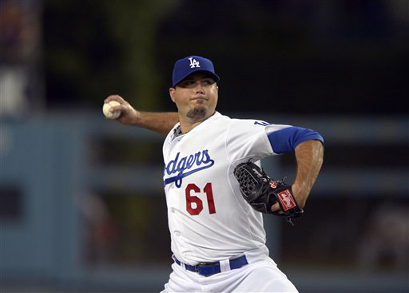 Los Angeles Dodgers starting pitcher Josh Beckett throws to the plate during the first inning of their baseball game against the St. Louis Cardinals, Thursday, Sept. 13, 2012, in Los Angeles. (AP Photo/Mark J. Terrill)