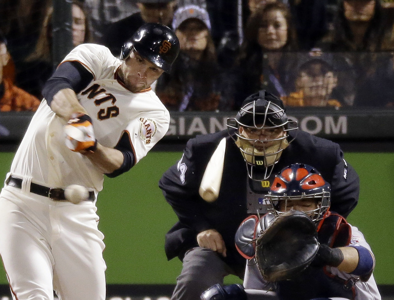 The Giants' Brandon Belt breaks his bat as he hits a single in the eighth inning of Game 6 of the National League championship series against the St. Louis Cardinals Sunday in San Francisco. The Giants won, 6-1.