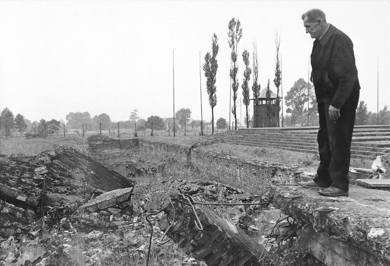 In this undated file photo from 1979, a former inmate of the Nazi concentration camp at Auschwitz-Birkenau, Poland, looks at ruins of gas chambers where hundreds of people were killed during World War II. The oldest known survivor of Auschwitz, a teacher who gave lessons in defiance of Nazi occupiers, has died at the age of 108. Antoni Dobrowolski died Sunday in the Polish town of Debno.