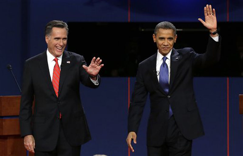Republican presidential nominee Mitt Romney and President Barack Obama wave to the audience during the first presidential debate at the University of Denver, Wednesday, Oct. 3, 2012, in Denver. (AP Photo/Charlie Neibergall)