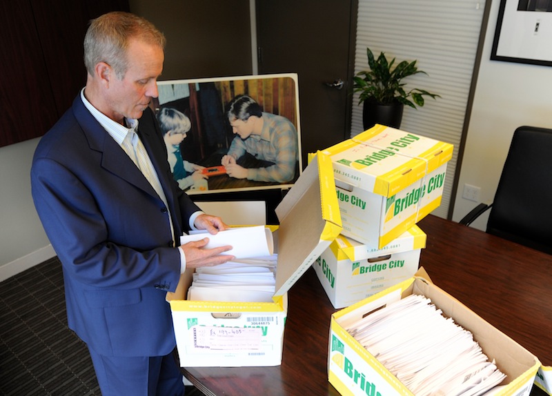 In this Tuesday, Oct. 16, 2012 photo, Portland attorney Kelly Clark examines some of the 14,500 pages of previously confidential documents created by the Boy Scouts of America concerning child sexual abuse within the organization, in preparation for releasing the documents Thursday, Oct. 18, in his office in Portland, Ore. The Boy Scouts of America fought to keep those files confidential. (AP Photo/Greg Wahl-Stephens)