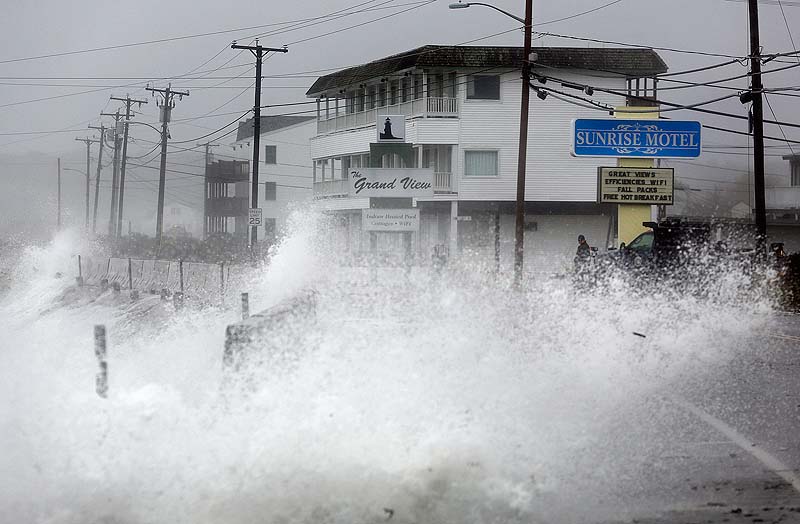 Waves crash over a sea wall along Long Beach Avenue in York, Monday, Oct. 29, 2012, as a result of weather conditions from Hurricane Sandy.