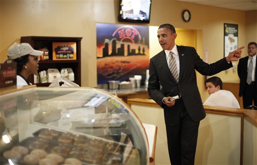 President Barack Obama makes an order during unannounced visit to Krispy Kreme Doughnuts, Thursday, Oct. 25, 2012, in Tampa, Fla. Obama, who traveled to Florida for a campaign event nearby, surprised local patrons when he drove up in the morning. (AP Photo/Pablo Martinez Monsivais)