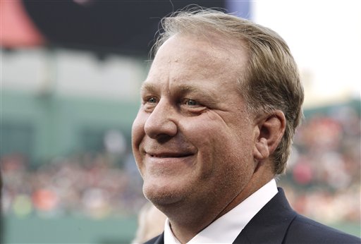 Former Boston Red Sox pitcher Curt Schilling smiling after being introduced as a new member of the Boston Red Sox Hall of Fame before the baseball game between the Boston Red Sox and the Minnesota Twins at Fenway Park in Boston. Schilling might have to sell the famed blood-stained sock he wore during the 2004 World Series to cover millions of dollars in loans he guaranteed to his failed video game company. Schilling, whose Providence-based 38 Studios filed for bankruptcy in June, listed the sock as collateral to a bank in a September filing with the Massachusetts Secretary of State. (AP Photo/Winslow Townson, File)