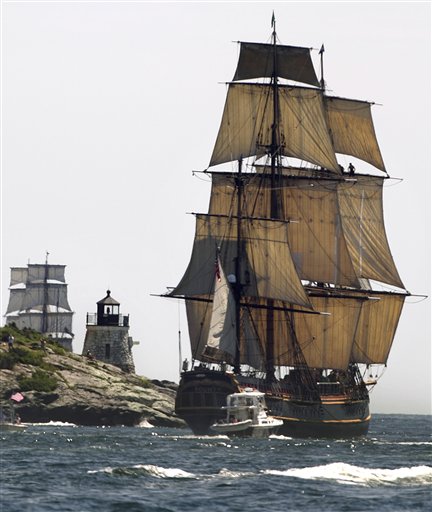 FILE - In this July 9, 2012, file photo, a replica of the historic ship HMS Bounty, right, sails past a lighthouse, center, as it departs Narragansett Bay and heads out to sea off the coast of Newport, R.I. The Coast Guard aid Monday, Oct. 29, 2012, that the 17 people aboard the HMS Bounty have gotten into two lifeboats, wearing survival suits and life jackets. The HMS Bounty, a tall ship, was in distress off North Carolina's Outer Banks as Hurricane Sandy swirls toward the East Coast. (AP Photo/Steven Senne, File)