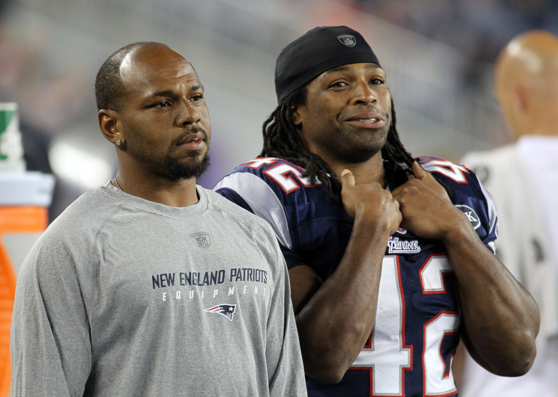 In this November 2011 file photo, Patriots running backs Kevin Faulk and BenJarvus Green-Ellis watch from the sidelines. Faulk is retiring from the Patriots after 13 years with the team.