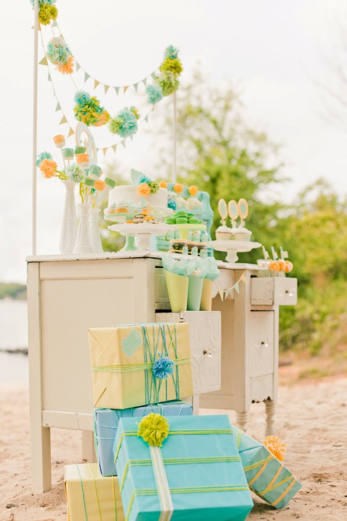 Designers and stylists Maureen Anders and Adria Ruff used a palette of mint, aqua, yellow and lime green for a gender-neutral baby shower. They incorporated handmade elements like wool pompoms and used paper, marshmallows and cake decorations to create centerpiece “flowers.”