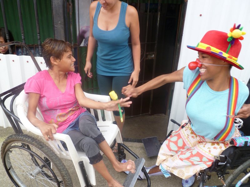 Elizabeth Meade has fun clowning in Costa Rica with Ingrid, left, who has cerebral palsy.