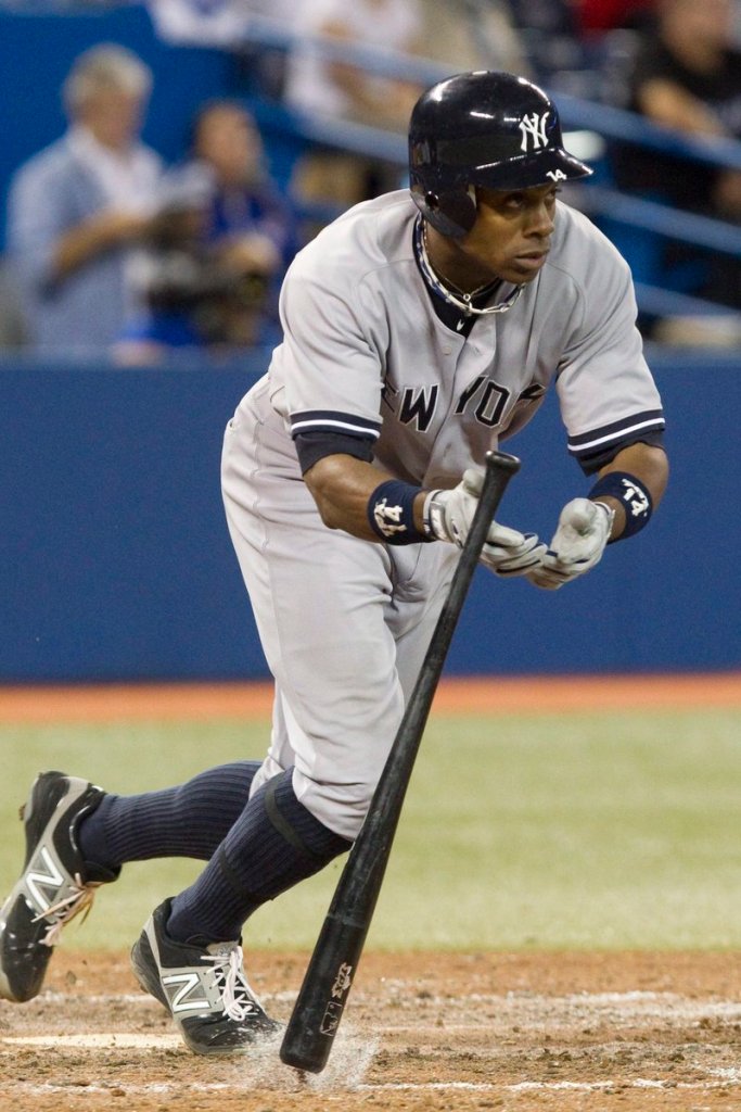 Curtis Granderson drops his bat after hitting a two-run single, which helped the Yankees win 9-6 at Toronto on Sunday.