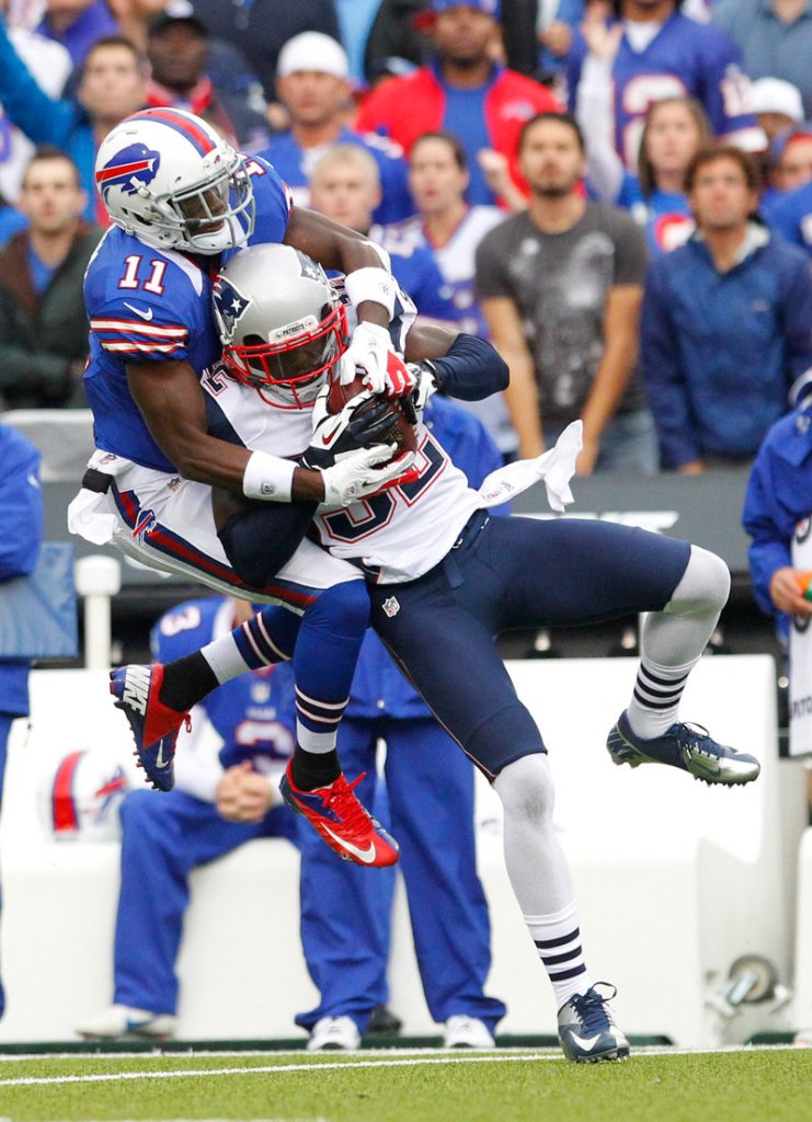 Devin McCourty of the New England Patriots intercepts a pass intended for T.J. Graham of the Buffalo Bills – one of the six turnovers that helped New England to a 52-28 victory.