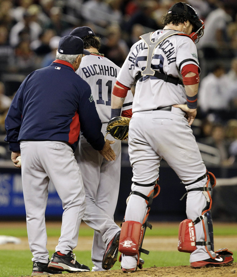 Boston starter Clay Buchholz gets a pat from Manager Bobby Valentine as catcher Jarrod Saltalamacchia walks away in the second inning Monday night in a 10-2 loss to the Yankees.