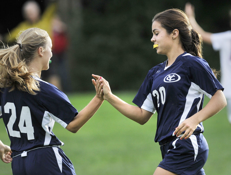 Eavan O’Neill of Yarmouth, right, is congratulated by Emma Torres after scoring the tying goal in the second half Tuesday in a 1-1 tie against Freeport.