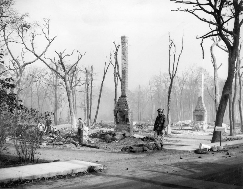 Only chimneys remain from houses consumed by one fire. Overall, more than 1,100 houses were destroyed.