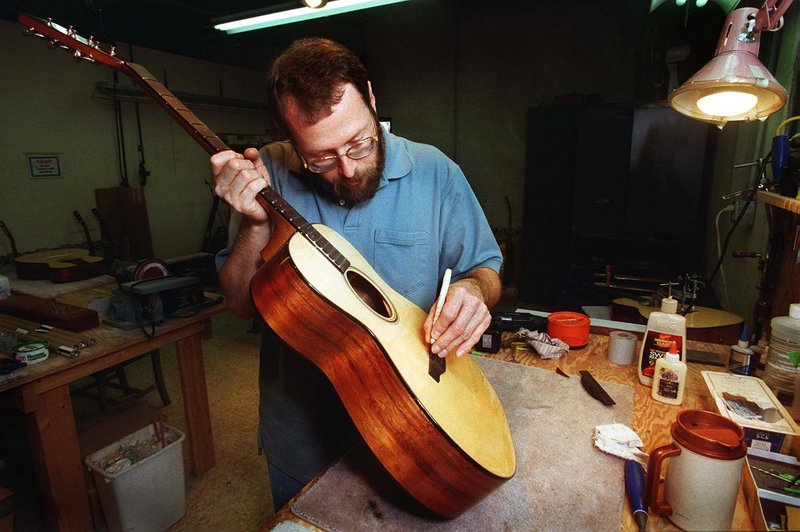 Dana Bourgeois of Lewiston works on a guitar in 2001, when his guitar shop was featured in a story in the Maine Sunday Telegram. The Bourgeois team is still on the cutting edge in the world of guitar-making.