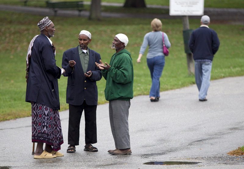 Somali men talk in Lewiston on Thursday. From 2000 to 2010, the city’s African-American population grew from 383 to 3,174, an increase of 828 percent. City officials say the number is perhaps as high as 6,000 today.