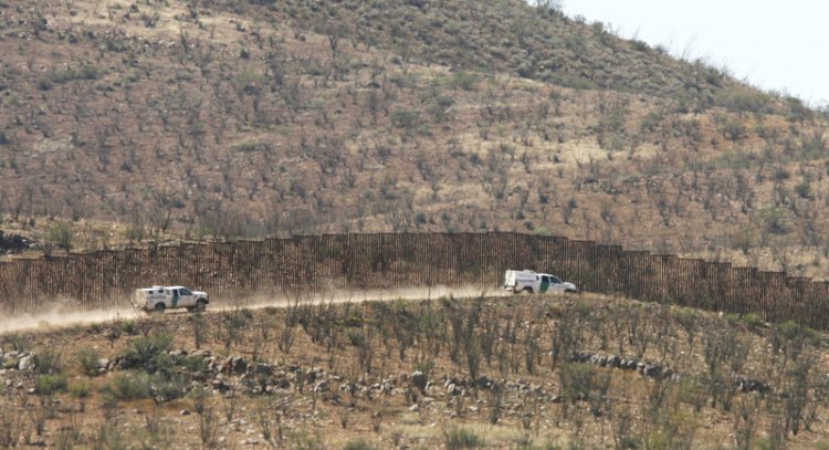 U.S. Border Patrol vehicles travel the U.S.-Mexico border in the area west of Douglas, Arizona, in 2014.