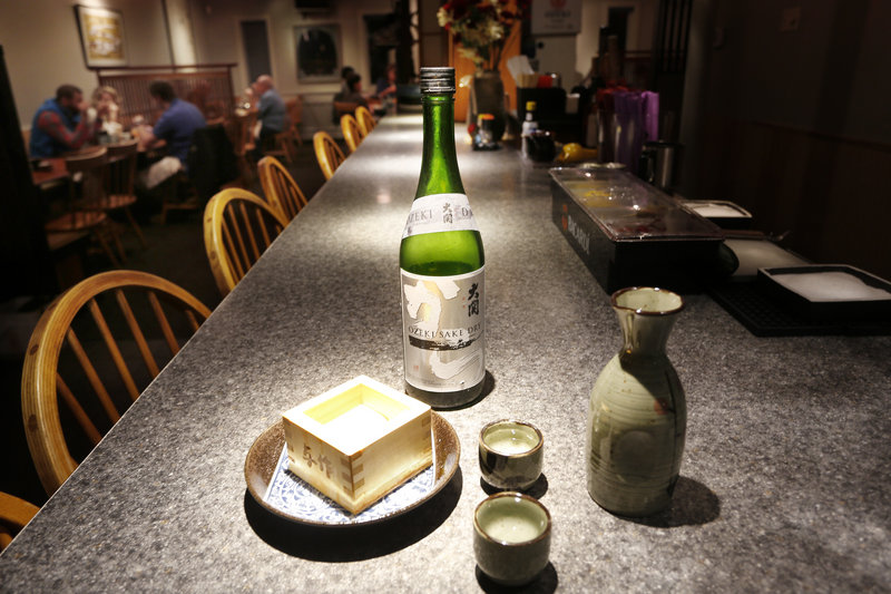 Sake with drinking cups and a cedar box, called a masu, at Yosaku in Portland.