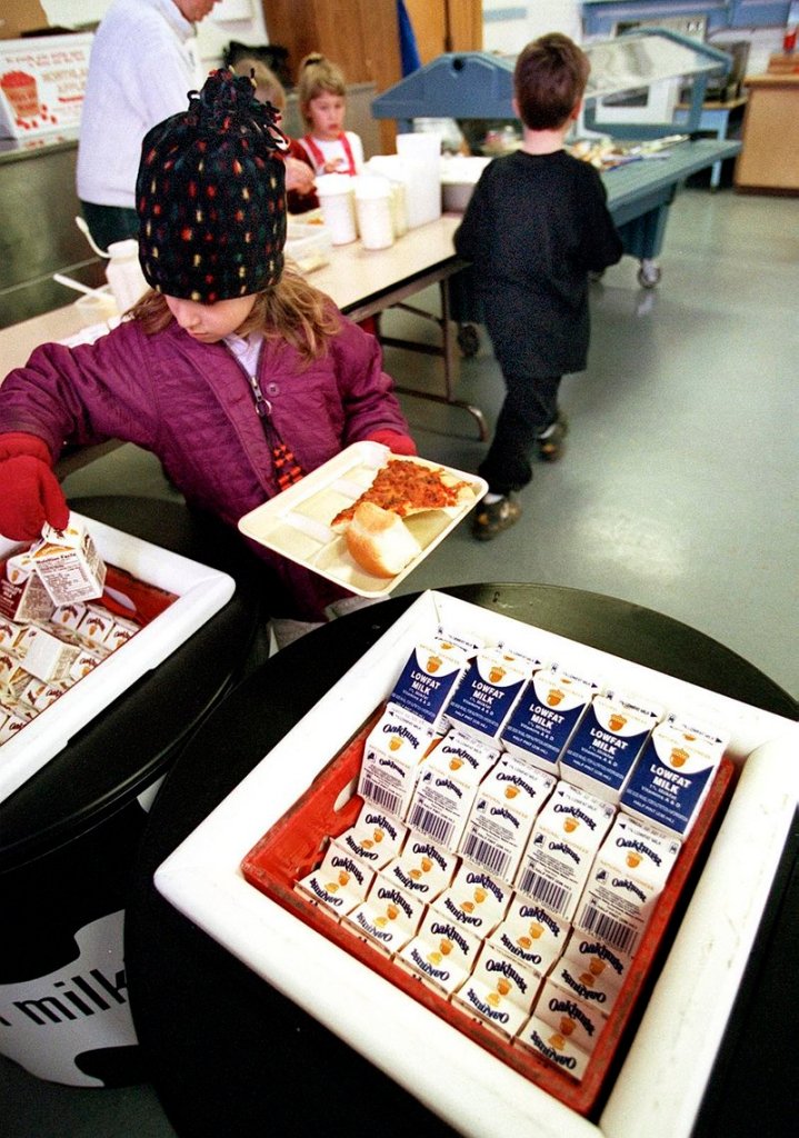Students choose from bins of low-fat milk at Brown Elementary School in South Portland. The Harvard Pilgrim Health Care Foundation is providing training to 178 Maine schools to improve school menus, the foundation’s director says.