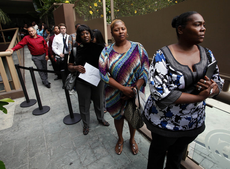 Job seekers await employment interviews at a job fair in Los Angeles in August.