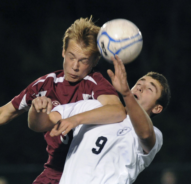 Mitchel Donovan, left, of Greely contends with Max Watson of Yarmouth for the ball during Greely’s 2-0 victory Thursday night at Yarmouth.