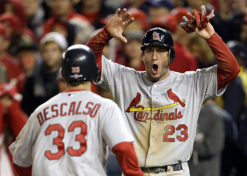 The Cardinals’ David Freese is clearly pumped up as he scores on a single by Pete Kozma in the ninth inning Friday. St. Louis rallied with four runs to stun the Nationals and advance to the NLCS.