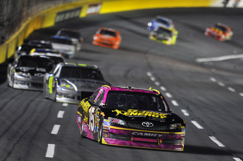 Clint Bowyer, 15, leads the pack during the NASCAR Sprint Cup Series race at Saturday night at Charlotte Motor Speedway. Bowyer won the race and moved up in the Chase for the Championship.