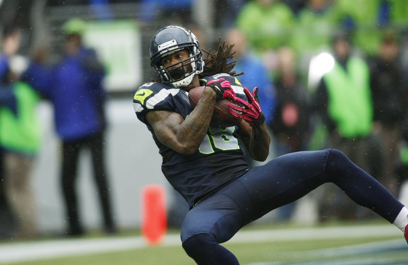 Seattle’s Sidney Rice hauls in the game-winning touchdown pass from Russell Wilson Sunday at Seattle. The Seahawks used three touchdown passes by Wilson to beat the Patriots, 24-23.
