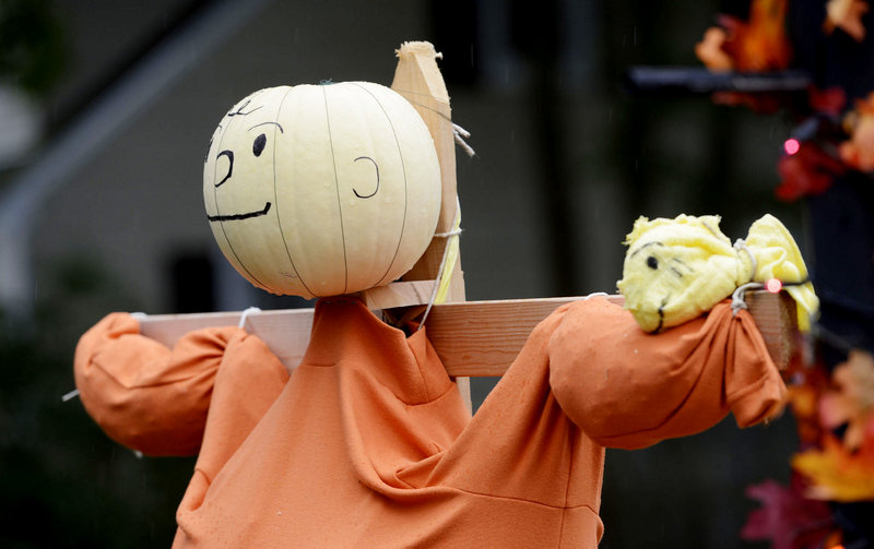 The Scifres family shows off a Charlie Brown scarecrow at their Cape Elizabeth home.