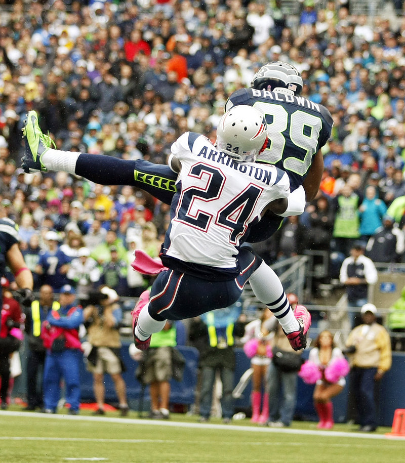 Doug Baldwin of the Seahawks makes a catch in front of Patriots cornerback Kyle Arrington in the first half Sunday at Seattle. The Seahawks pulled out a 24-23 win.