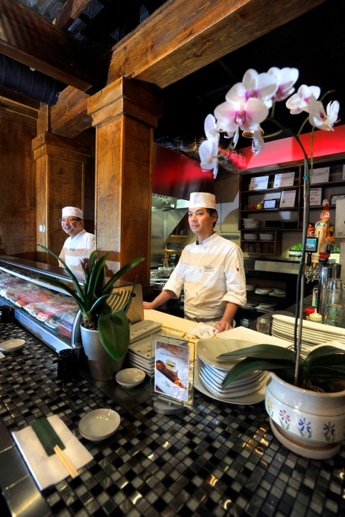 Seiji Ando, left, and Richie Akizaki work behind the sushi bar at Kushiya Benkay.