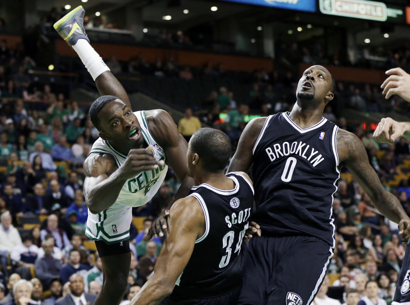 Jeff Green of the Boston Celtics heads to the ground Tuesday night after driving against Carleton Scott, left, and Andray Blatche of the Brooklyn Nets. Green scored 14 points in a 97-96 loss.