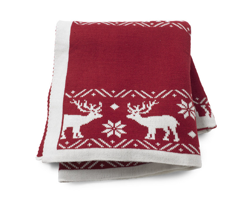 Reindeer and snowflakes adorn a throw from HomeGoods.com.