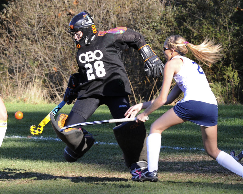 Massabesic goalkeeper Abby Greenleaf turns away a shot Wednesday as Siobhan Foley of Westbrook looks for a rebound during their Western Class A field hockey quarterfinal. Westbrook won 1-0 and will play Saturday at top-ranked Scarborough.