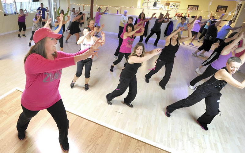 Susan Sinnett leads a fitness class at Studio Fit of Maine in Portland on Wednesday.