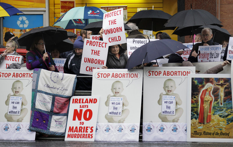 Protesters opposed to abortion hold placards Thursday outside the Marie Stopes clinic in Belfast, Northern Ireland, where the first abortion clinic on the island of Ireland has opened, sparking protests by both Catholics and Protestants.