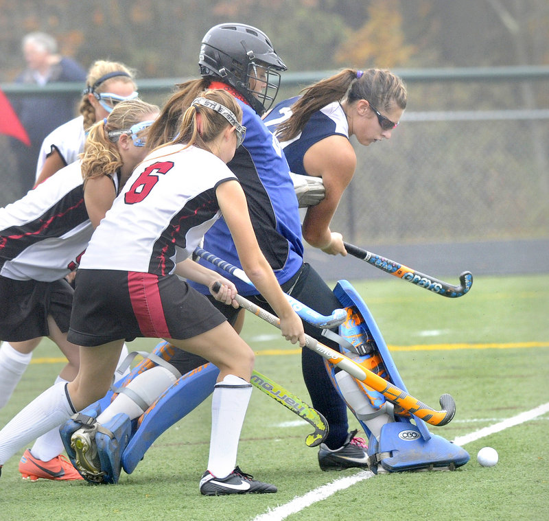 Westbrook goalie Nicole Miranda attempts to clear the ball, helped by teammate Emily Blackmore, as Rachael Wallace of Scarborough, 6, reaches for the ball.
