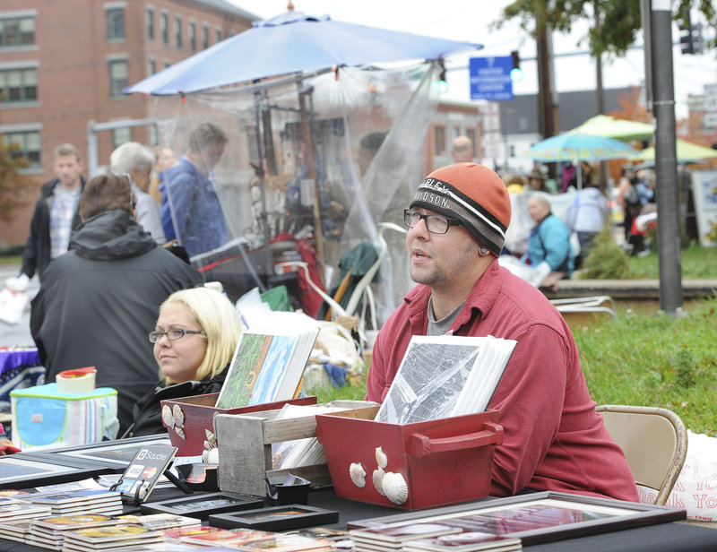 Amy Hague of Buxton and Al Farrisio of Fort Myers, Fla., sells their wares on Commercial Street in Portland on Saturday. More than 60 merchants have signed a petition asking the city to crack down on street vendors.