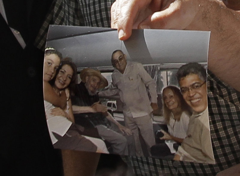 Former Venezuelan Vice President Elias Jaua shows a picture of Cuba’s retired president, Fidel Castro, third from left, at the Hotel Nacional in Havana on Sunday. According to Jaua, the picture was taken Saturday inside a van outside the hotel and shows Castro looking “very well.”