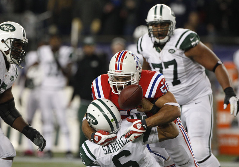 Rob Ninkovich separates Jets quarterback Mark Sanchez from the ball to preserve the Patriots’ 29-26 overtime victory over New York Sunday at Gillette Stadium in Foxborough, Mass.