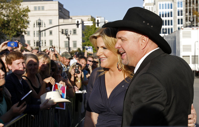 Garth Brooks and his wife, singer Trisha Yearwood, greet fans Sunday before Brooks, singer Connie Smith and keyboard player Hargus “Pig” Robbins were inducted into the Country Music Hall of Fame.