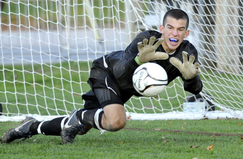Chip Weber makes a diving save Monday during Portland’s Western Class A boys’ soccer prelim against Windham. The 10th-ranked Bulldogs won in double overtime, 2-1, and advanced to the quarterfinals against No. 2 Scarborough.