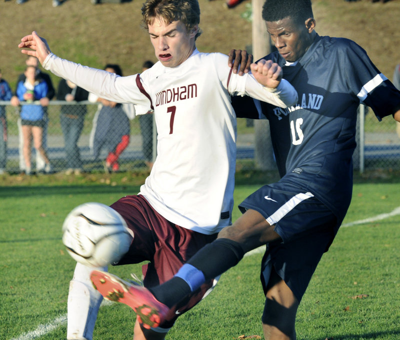 Ibrahim Dahir, right, of Portland kicks the ball away from Marc Reynolds, who scored the only goal for Windham.