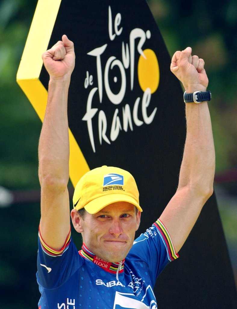 Lance Armstrong gestures from the podium after winning his fifth consecutive Tour de France in 2003. He also won the next two races, but was stripped of the seven titles on Monday.