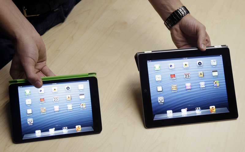 The iPad Mini, at left, is shown next to the 4th Generation iPad in San Jose, Calif., on Tuesday.