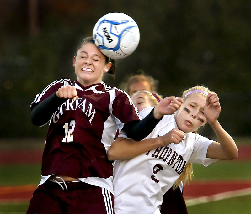 Lauren Stiles of Gorham, left, heads the ball away from Tori Daigle of Thornton Academy during their Western Class A quarterfinal Tuesday. Thornton advanced with a 2-0 victory at Saco.