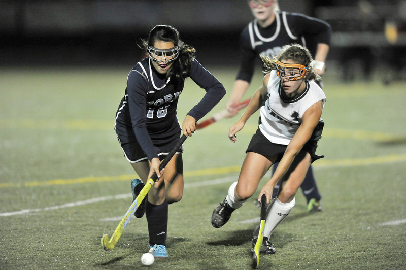 Olivia Drew of York, left, controls the ball and looks for a way around Sadie Rover of Leavitt during their Western Class B field hockey final Tuesday at Scarborough. Leavitt ended York’s four-year reign, 1-0.