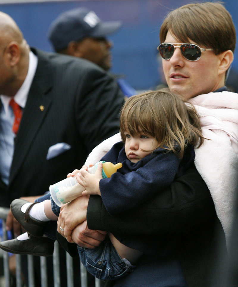 Actor Tom Cruise holds his daughter Suri. The actor is suing Life & Style magazine for articles that said Cruise abandoned his 6-year-old daughter. Cruise called the claim a “vicious lie.”