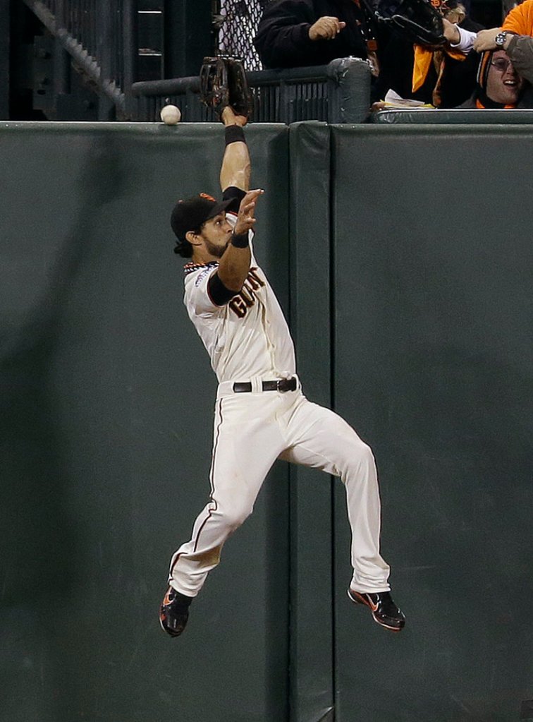 Angel Pagan, the center fielder for the San Francisco Giants, comes up just short of nabbing a two-run homer by Jhonny Peralta of the Detroit Tigers in the ninth inning of the World Series opener Wednesday night.